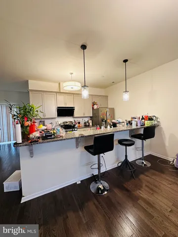a kitchen with a sink cabinets and wooden floor