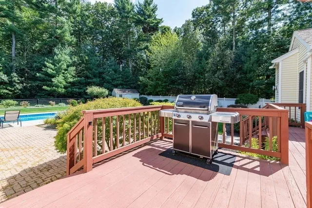 a view of a deck with wooden floor and barbeque oven