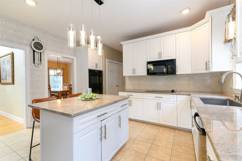 53 Queens Circle Raynham, MA 02767 - Photo 20 of 38 a kitchen with a sink stove and cabinets