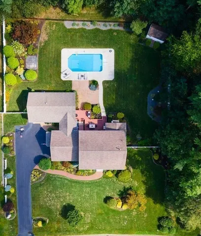 an aerial view of residential house with outdoor space and pool
