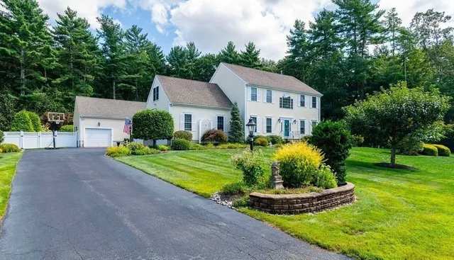 a front view of a house with a yard and porch