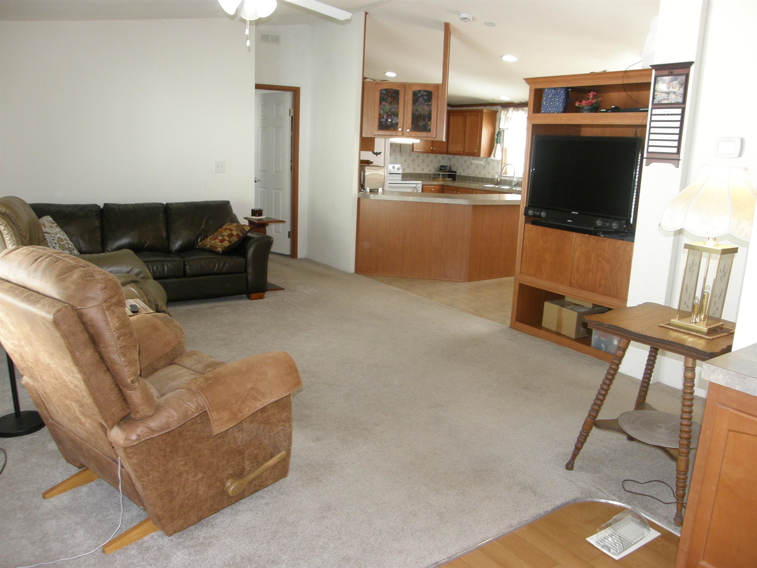 435 32 Road, Unit 262 Clifton, CO 81520 - Photo 11 of 42 a living room with furniture and a flat screen tv