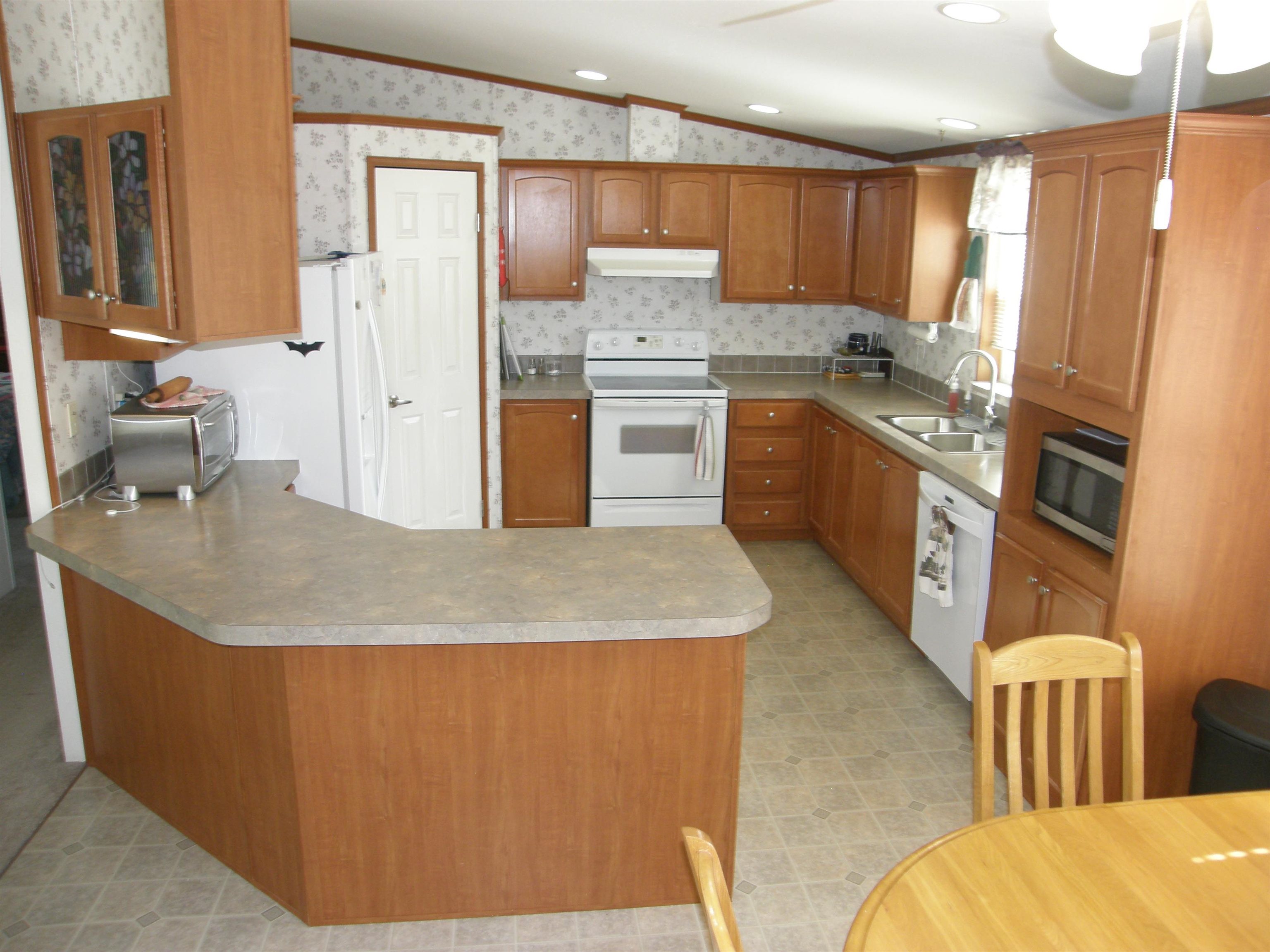 435 32 Road, Unit 262 Clifton, CO 81520 - Photo 19 of 42 a kitchen with stainless steel appliances granite countertop a sink refrigerator and cabinets