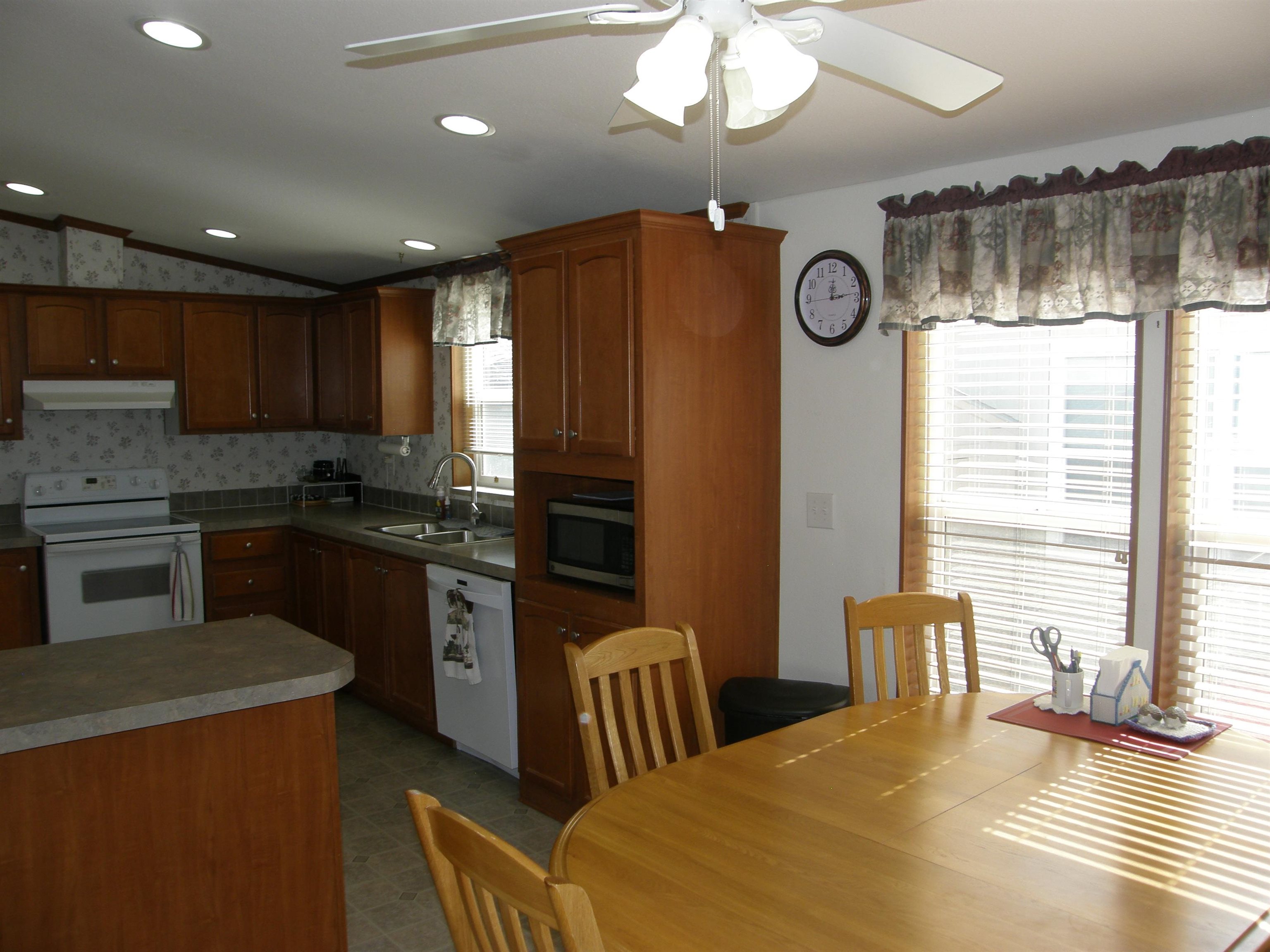 435 32 Road, Unit 262 Clifton, CO 81520 - Photo 22 of 42 a kitchen with stainless steel appliances granite countertop a sink a stove a refrigerator cabinets and a dining table