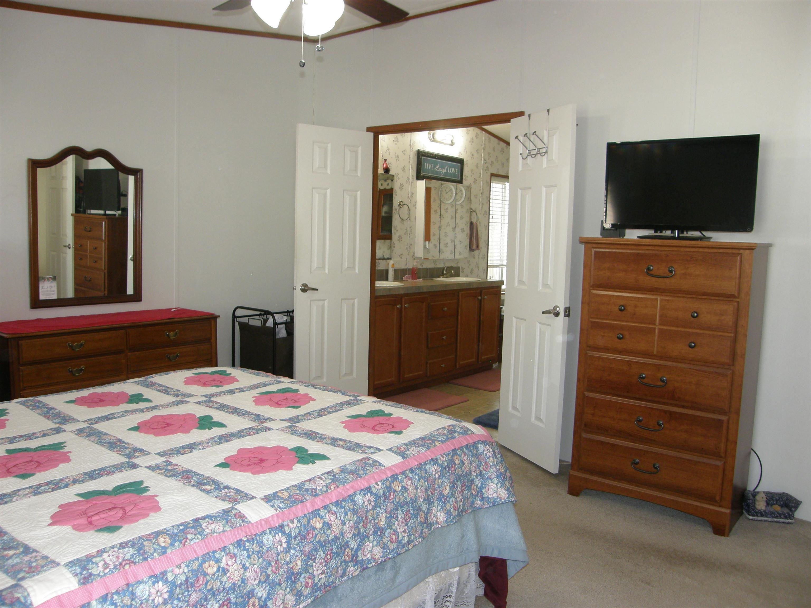 435 32 Road, Unit 262 Clifton, CO 81520 - Photo 27 of 42 a bedroom with a bed and a flat screen tv