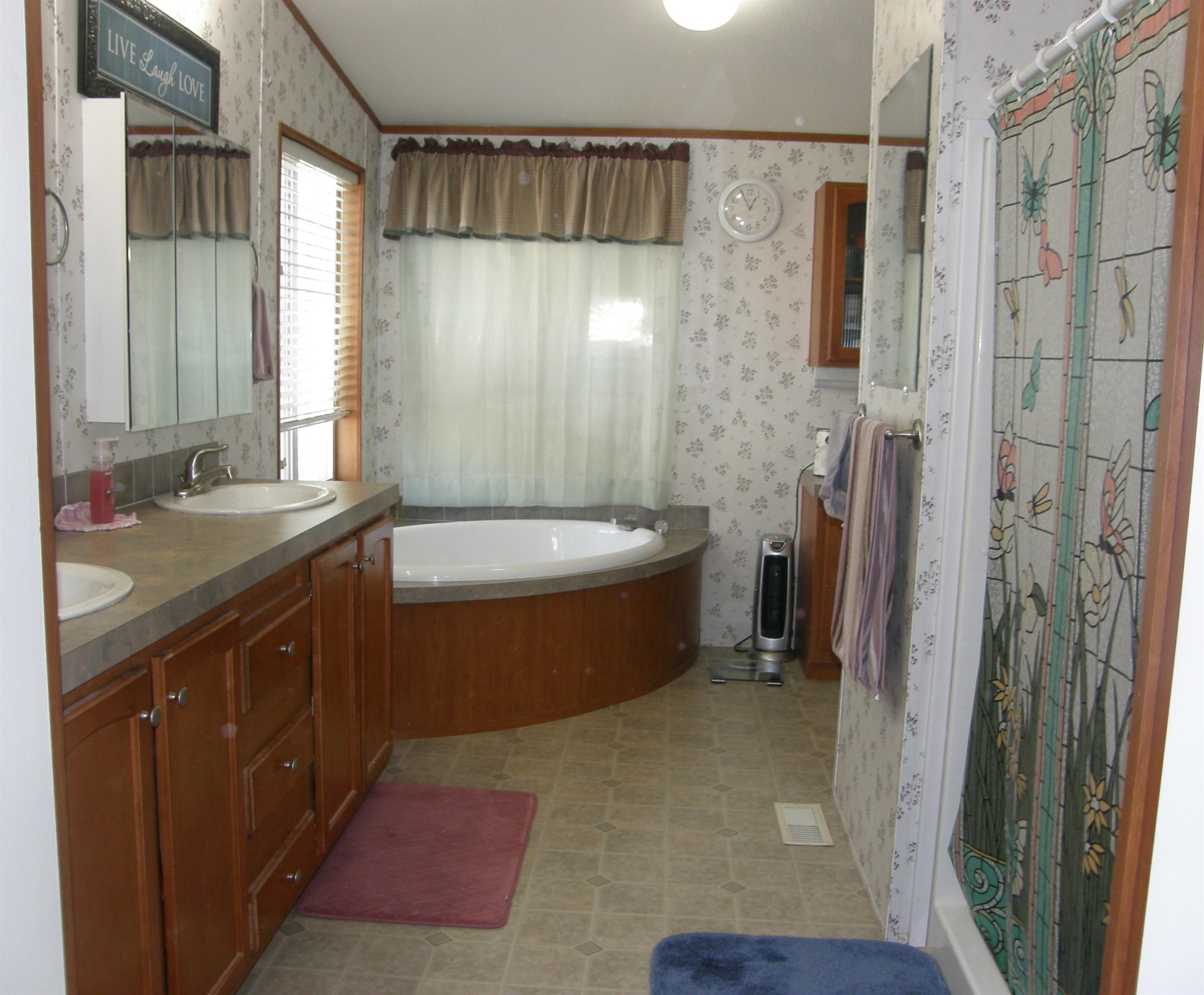435 32 Road, Unit 262 Clifton, CO 81520 - Photo 28 of 42 a bathroom with a double vanity sink a toilet a mirror and shower