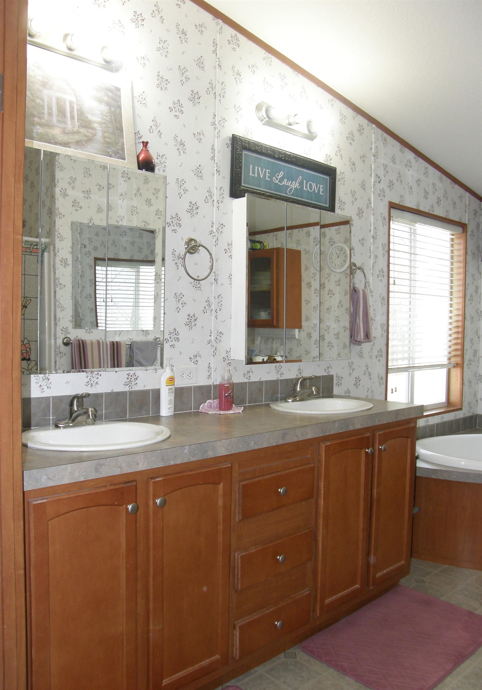 435 32 Road, Unit 262 Clifton, CO 81520 - Photo 29 of 42 a bathroom with a granite countertop sink a large mirror and a window