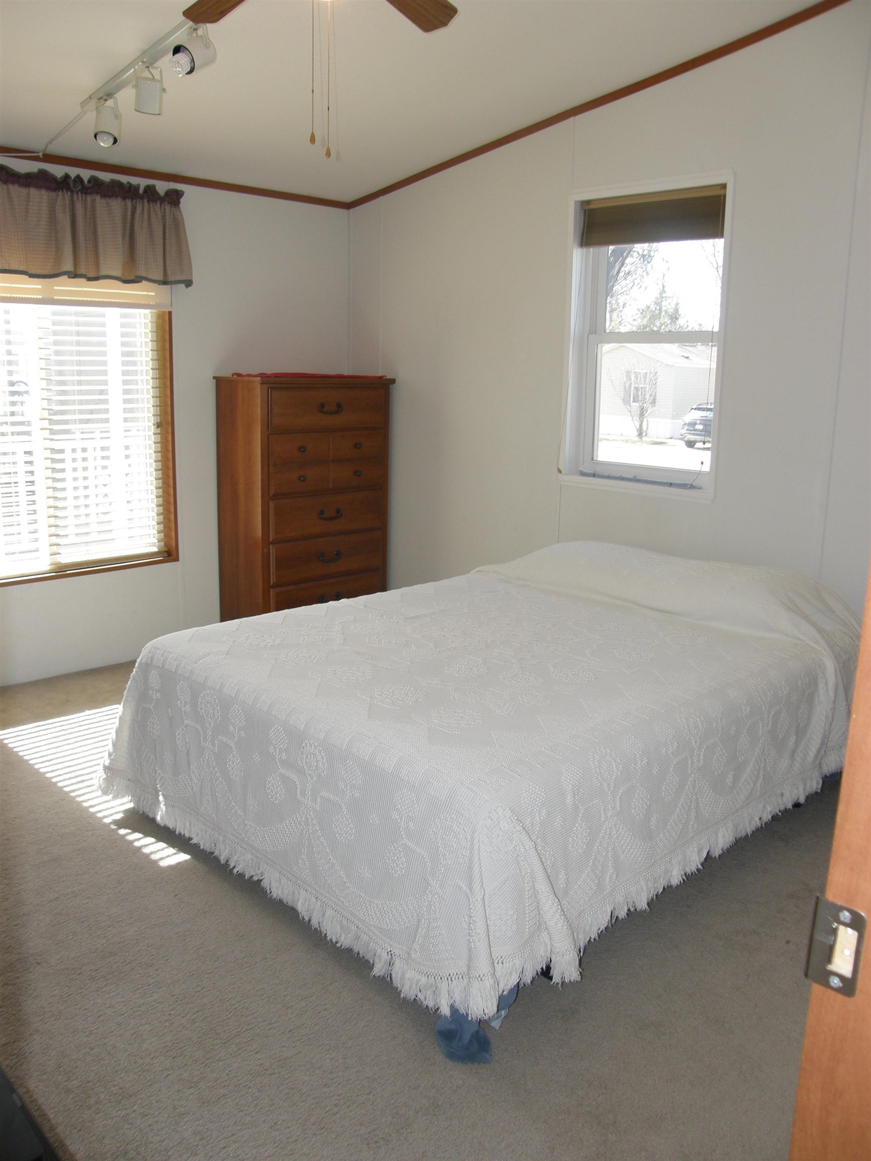 435 32 Road, Unit 262 Clifton, CO 81520 - Photo 37 of 42 a bed sitting in a bedroom next to a window