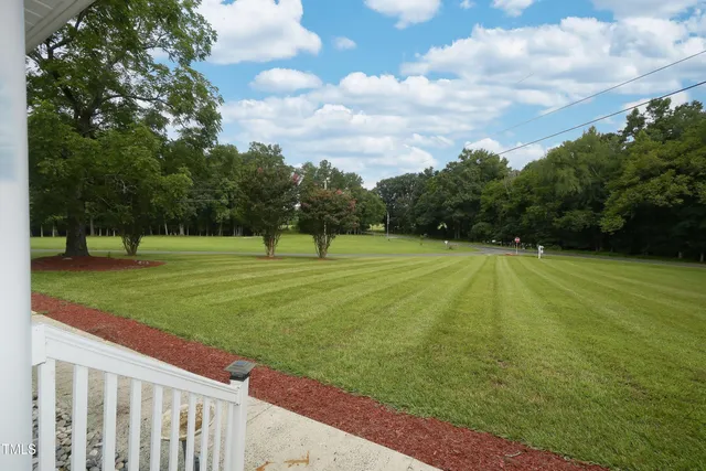 a dining room with wooden floor and furniture