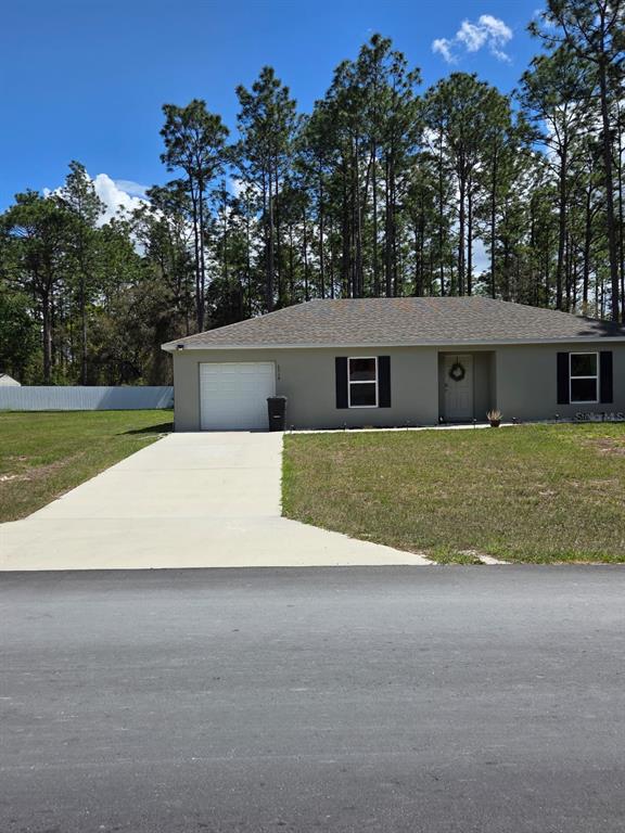 6918 Southwest 144th Lane Ocala, FL 34473 - Photo 2 of 6 a view of a house with a yard