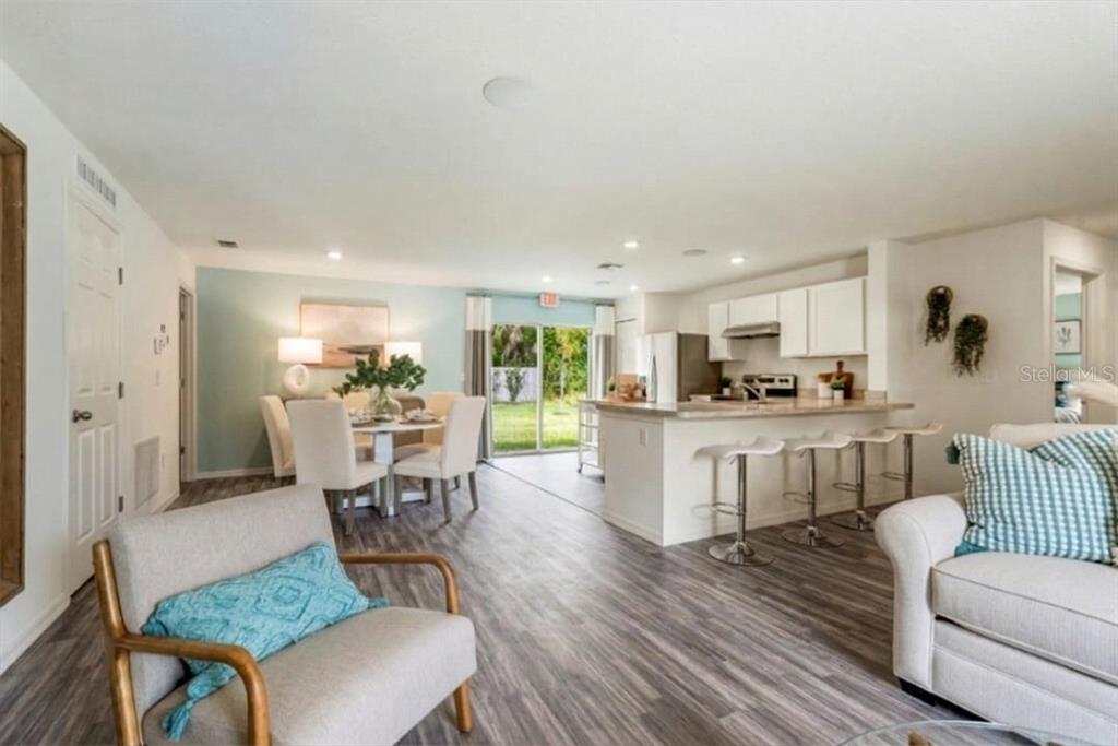 6918 Southwest 144th Lane Ocala, FL 34473 - Photo 3 of 6 a living room with furniture and kitchen view