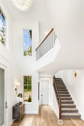 a view of entryway and hall with wooden floor