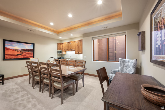 2331 West Entrada Trail, Unit 61 St. George, UT 84770 - Photo 37 of 69 Spacious room featuring tray ceiling with accent lighting, recessed lighting, and soft carpet flooring