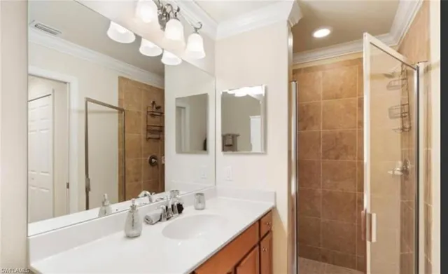a bathroom with a sink vanity granite shower and a mirror