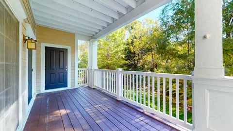a view of empty room with wooden floor and floor to ceiling window