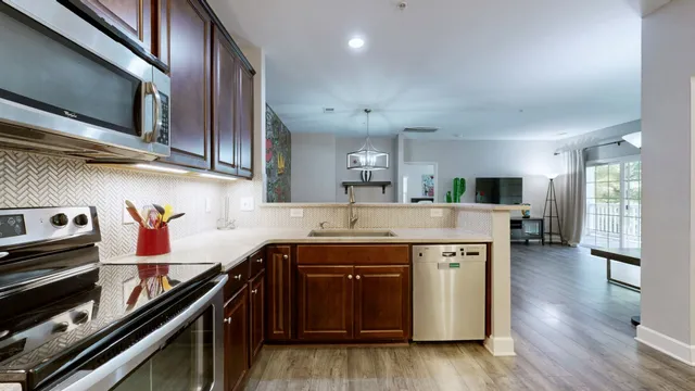 a view of a dining room with furniture wooden floor and chandelier