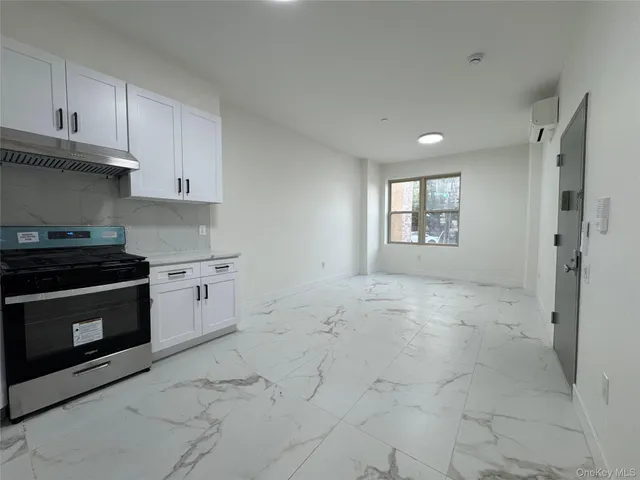 a kitchen with a stove a sink and a refrigerator