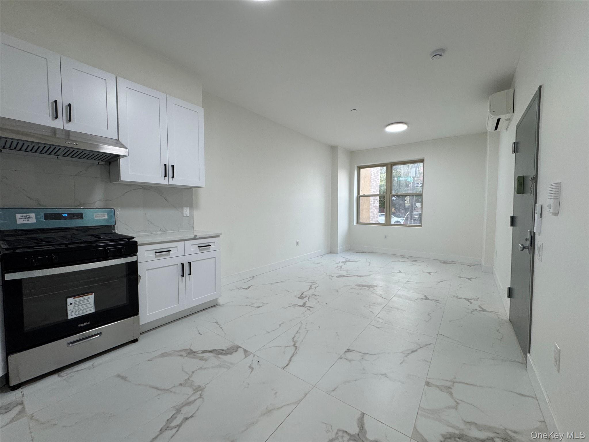 101-12 Martense Avenue Queens, NY 11368 - Photo 2 of 8 a kitchen with a stove a sink and a refrigerator