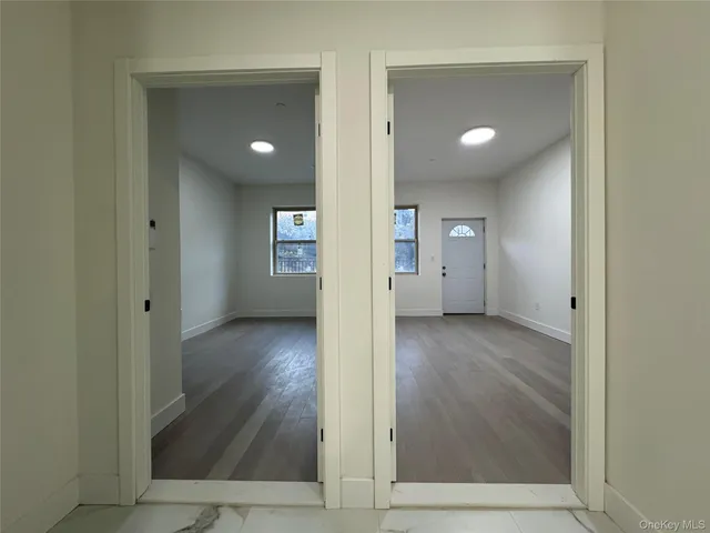 a view of hallway with wooden floor