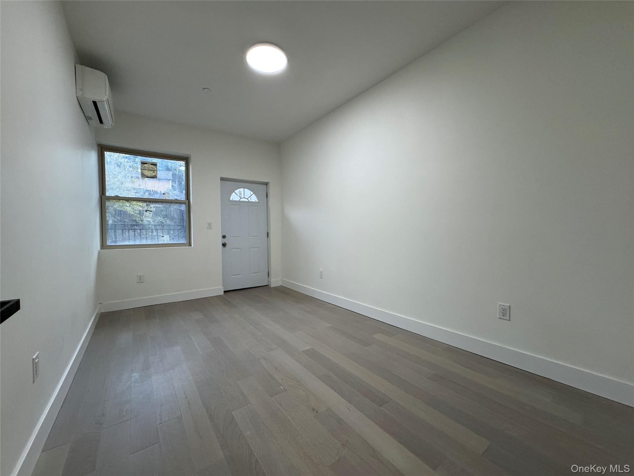 101-12 Martense Avenue Queens, NY 11368 - Photo 6 of 8 an empty room with a window