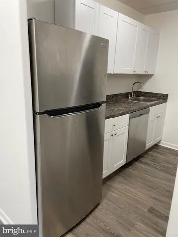 a white refrigerator freezer sitting in a kitchen