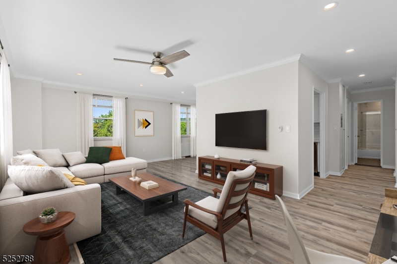 36 Hawthorne Place, Unit 2I Montclair, NJ 07042 - Photo 3 of 23 a living room with furniture and a flat screen tv