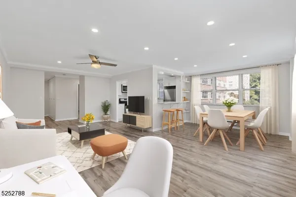 a living room with furniture a wooden floor and a table