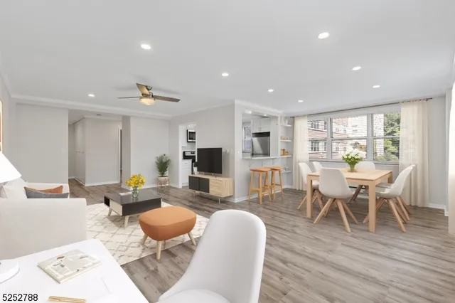 a living room with furniture a wooden floor and a table
