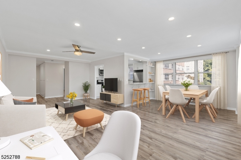 36 Hawthorne Place, Unit 2I Montclair, NJ 07042 - Photo 7 of 23 a living room with furniture a wooden floor and a table