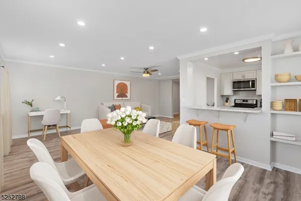 a dining room filled chandelier and kitchen view