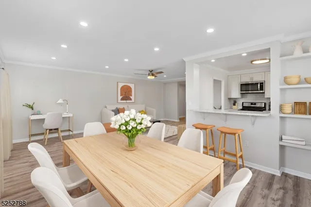a dining room filled chandelier and kitchen view
