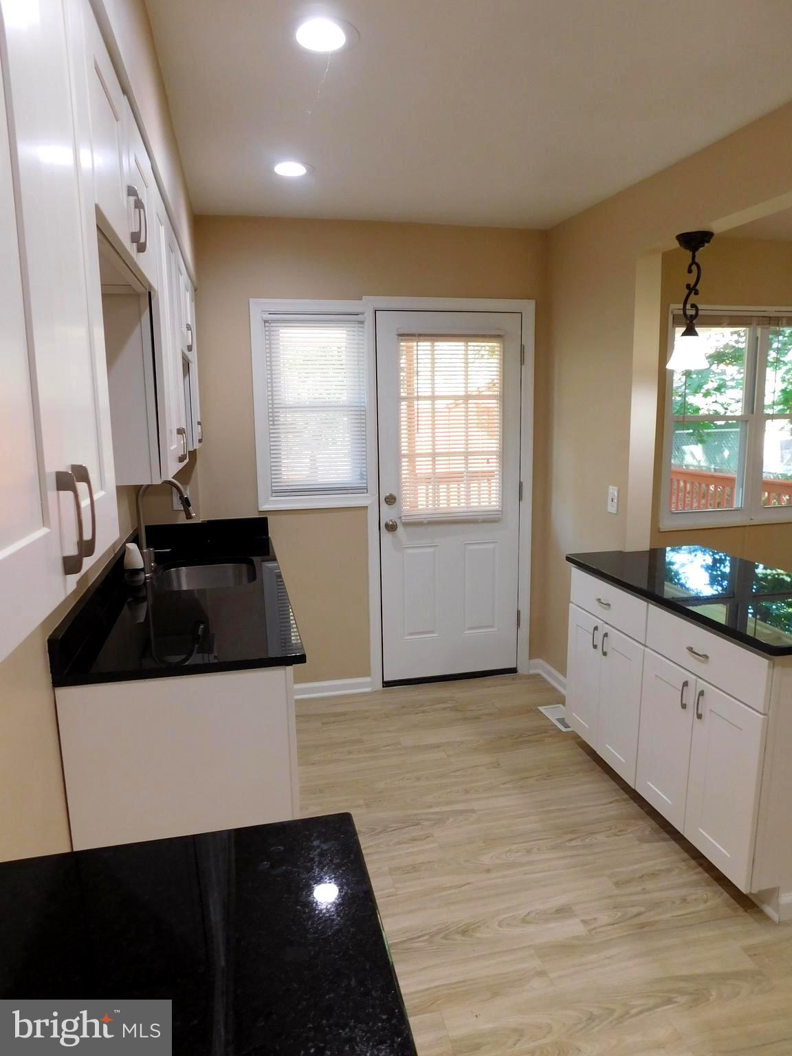 618 Brisbane Road Baltimore, MD 21229 - Photo 14 of 30 a kitchen with granite countertop a sink and a stove top oven