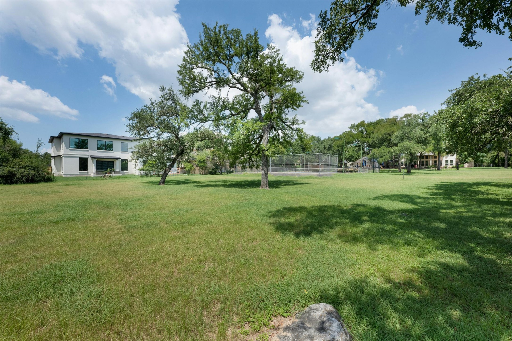9911 Anderson Mill Road Austin, TX 78750 - Photo 3 of 29 A generous grassy lot with mature shade trees, offering ample space for recreation and future expansion.