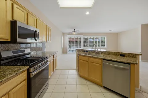 a kitchen with stainless steel appliances granite countertop a stove and a sink