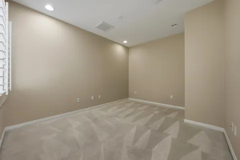 a living room with furniture potted plant and white walls