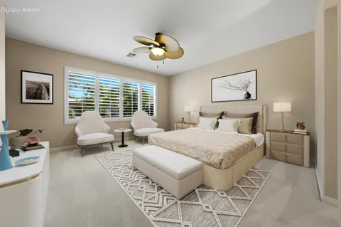 an empty room with a chandelier fan and windows