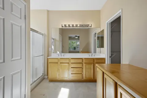 a bathroom with a sink a mirror and a shower