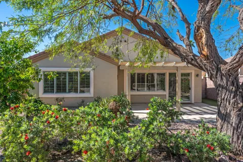 a front view of a house with a garden