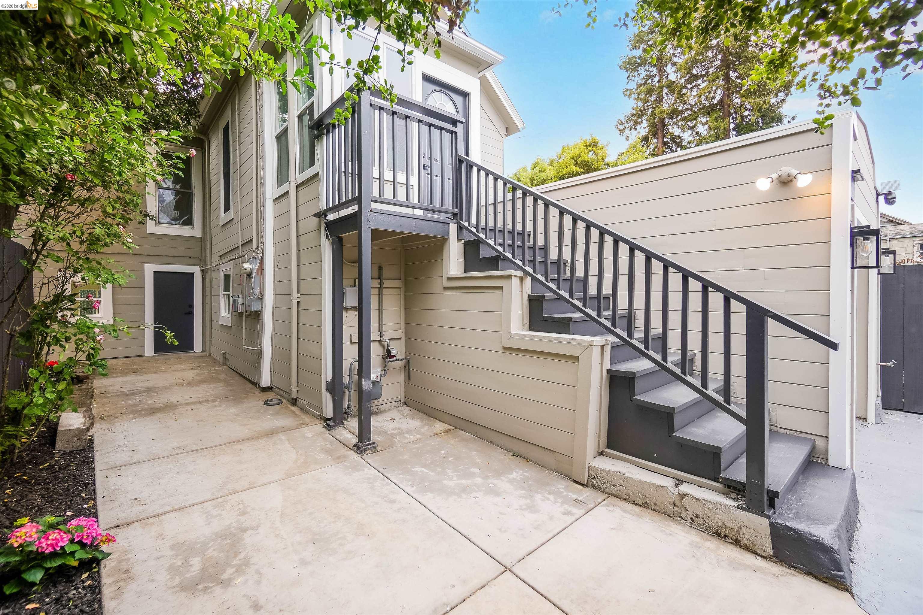 1812 Woolsey Street Berkeley, CA 94703 - Photo 31 of 48 Exterior staircase with black railings leading to an upper-level entry