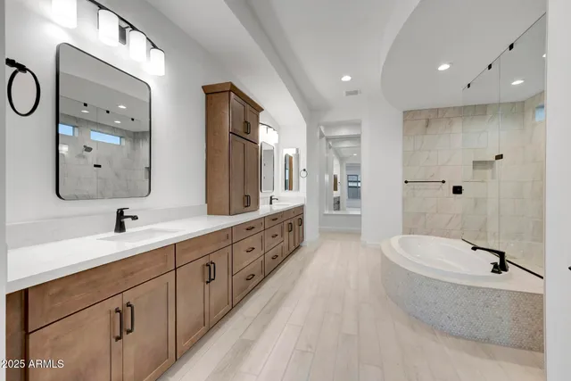 a spacious bathroom with double sink and a mirror