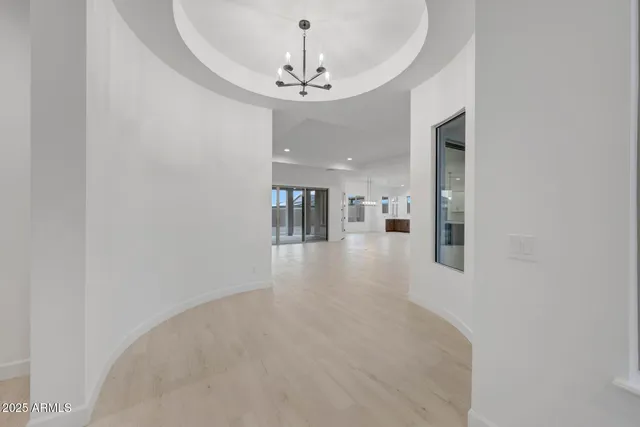a view of a big room with chandelier fan and fire place