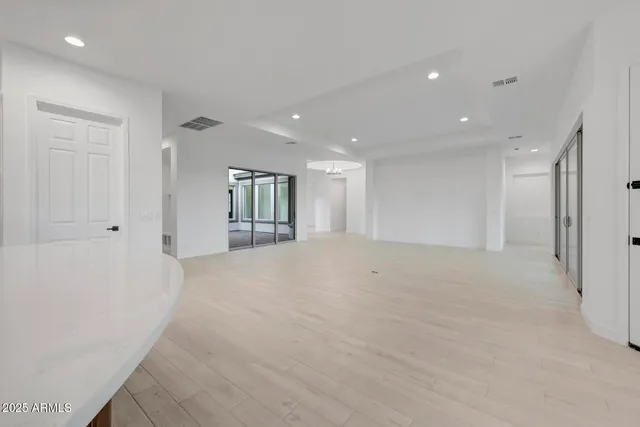 a large kitchen with stainless steel appliances granite countertop a large counter top a stove and a sink