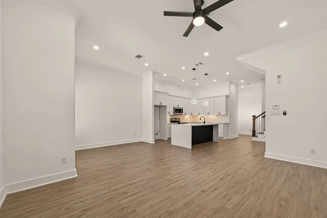 a view of a kitchen with a sink stainless steel appliances and cabinets