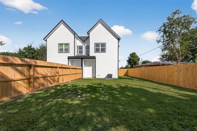 an aerial view of houses with yard