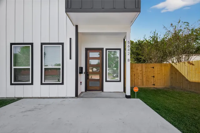 front view of a house with a yard and an window