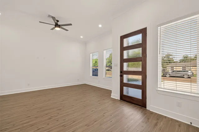 wooden floor in an empty room with a window