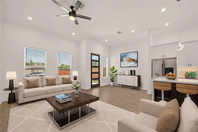 a living room with furniture kitchen view and a window