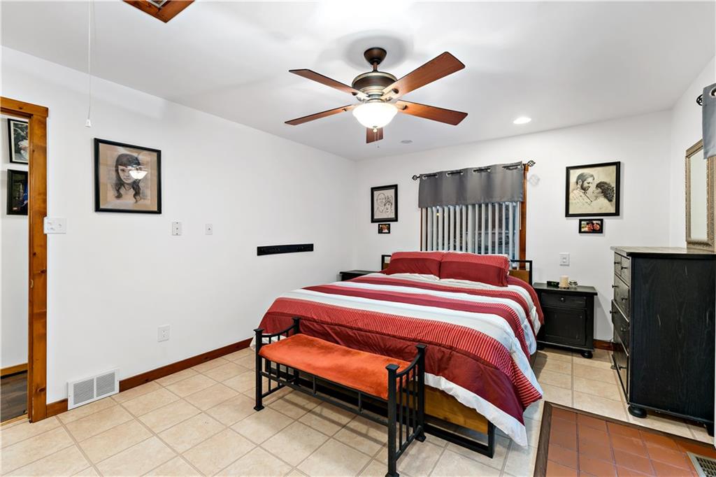 3354 Millers Run Road Cecil, PA 15321 - Photo 13 of 45 a bedroom with bed and a chandelier