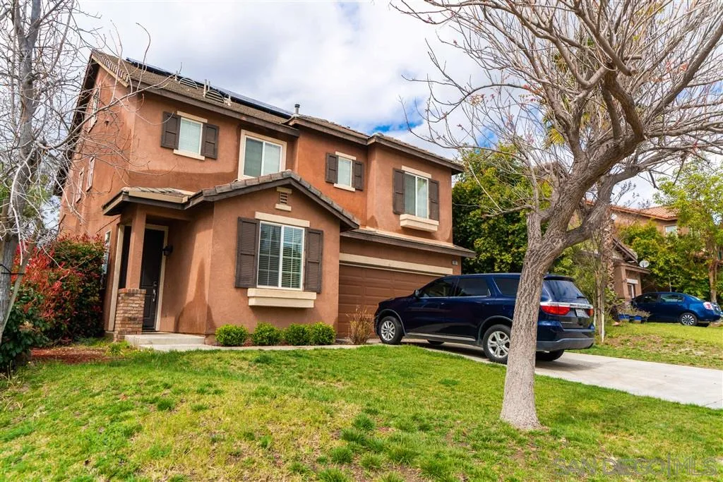 38917 Rockinghorse Road Murrieta, CA 92563 - Photo 2 of 22 a front view of a house with a yard and garage