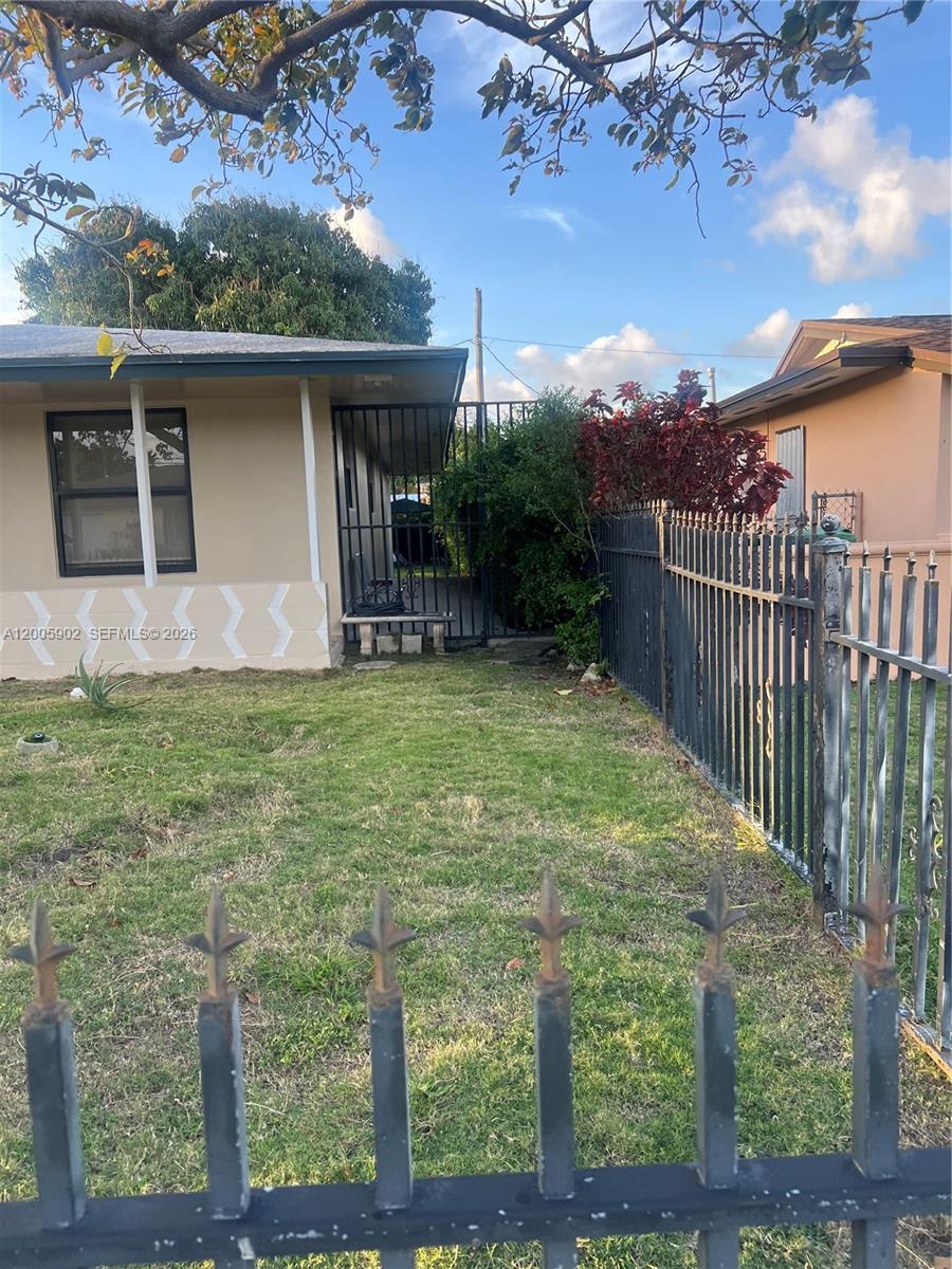 9945 Southwest 164th Terrace, Unit 1 Miami, FL 33157 - Photo 6 of 8 a view of a house with a yard